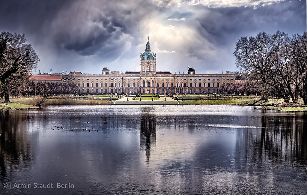 HDR shot of Schloss Charlottenburg Berlin with dramatic sky and lake