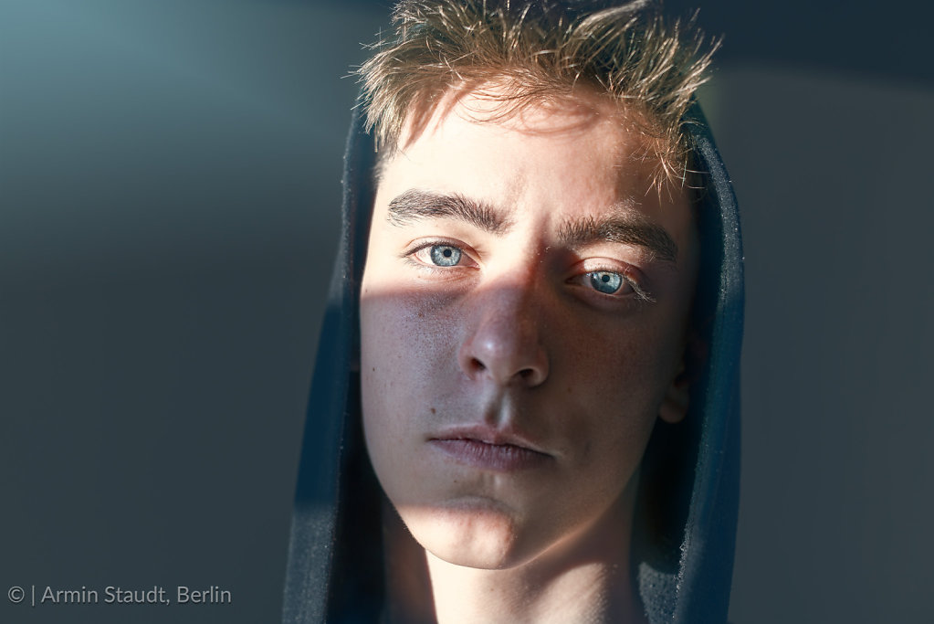 close up portrait of a young man with hoodie