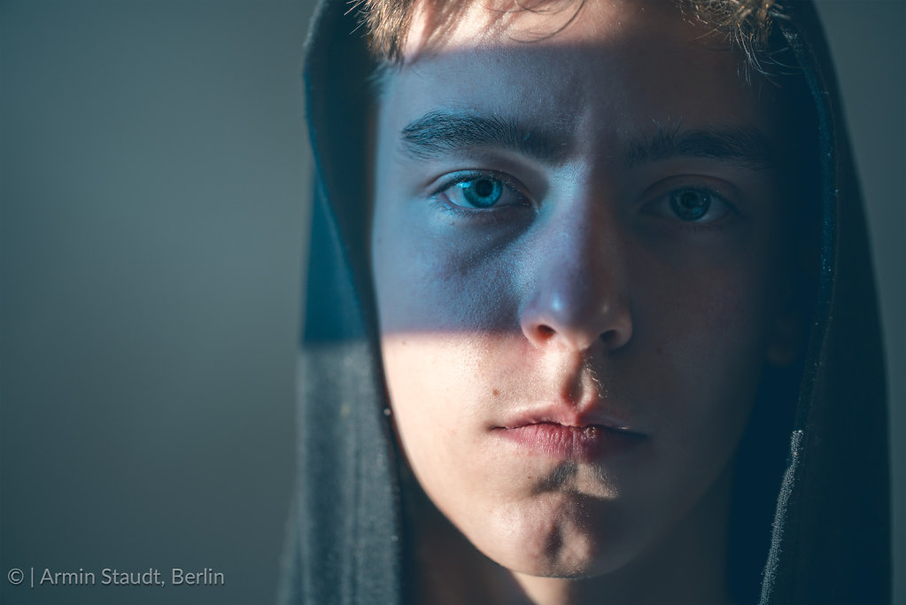 close up portrait of a young man with hoodie